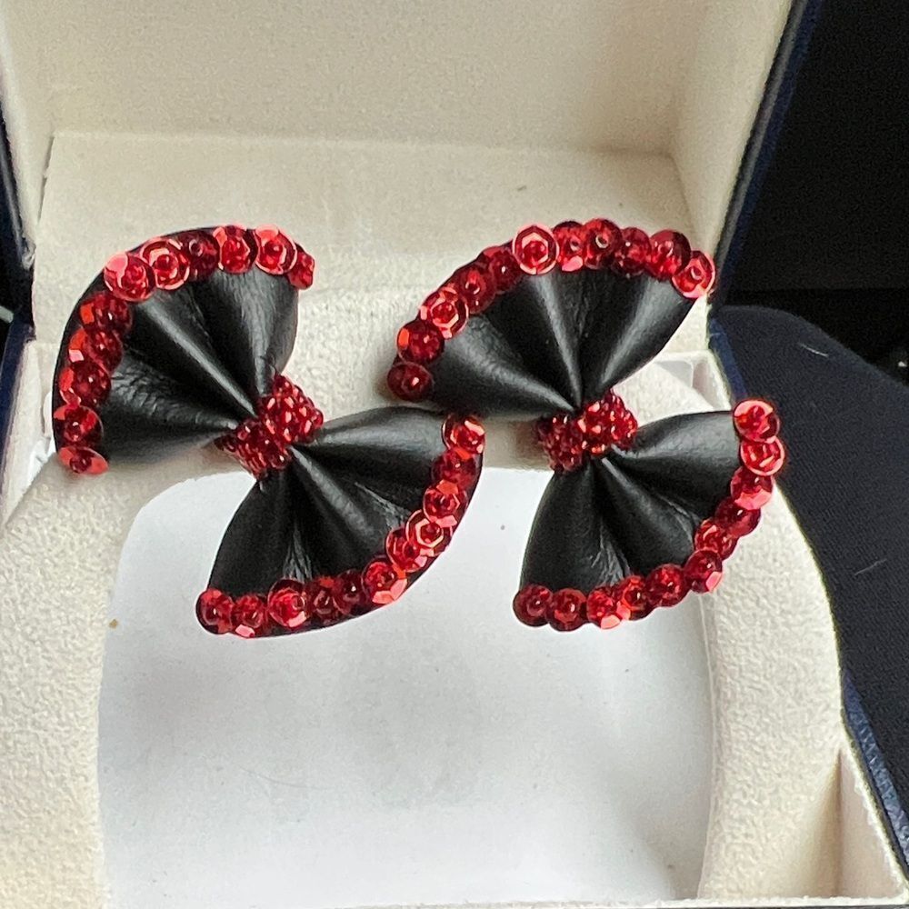 Black bow with red sequin pierced earrings.